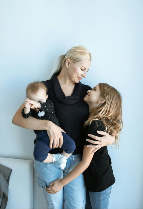 a woman holding a baby and a baby