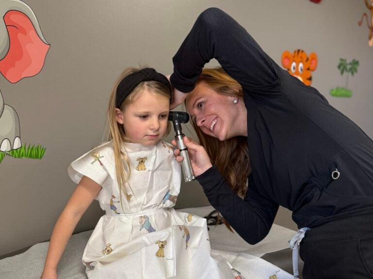 recurrent ear infections — toddler tugging at an ear while a parent comforts them
